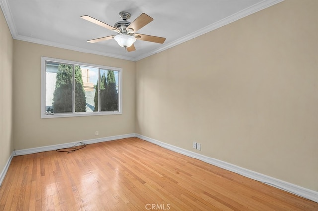 empty room with ornamental molding, light hardwood / wood-style floors, and ceiling fan