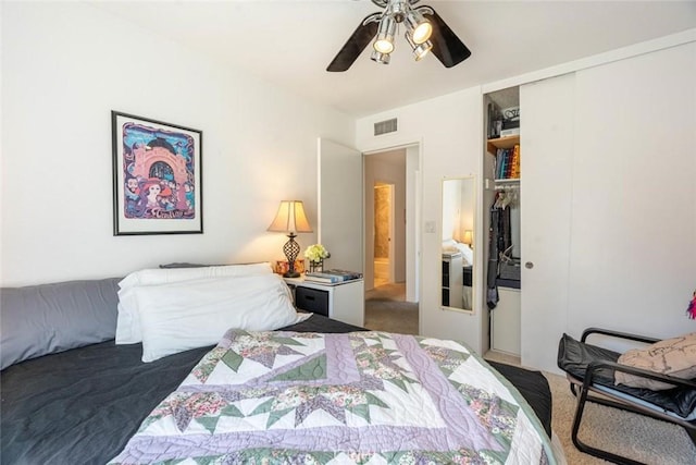 bedroom with a closet, ceiling fan, and dark colored carpet