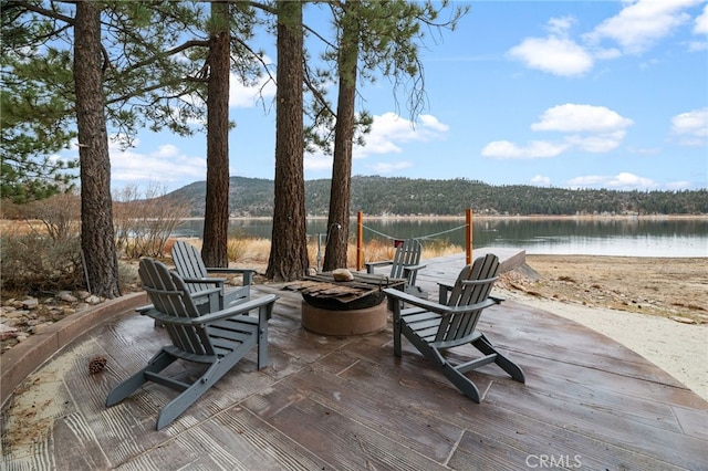 view of patio / terrace featuring a water view and an outdoor fire pit