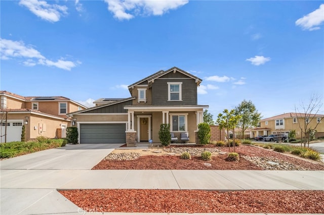 craftsman inspired home featuring stucco siding, roof mounted solar panels, covered porch, concrete driveway, and a garage