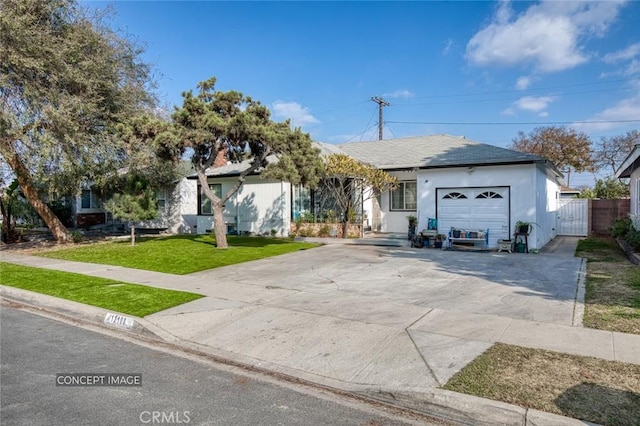 view of front of house with a garage and a front lawn