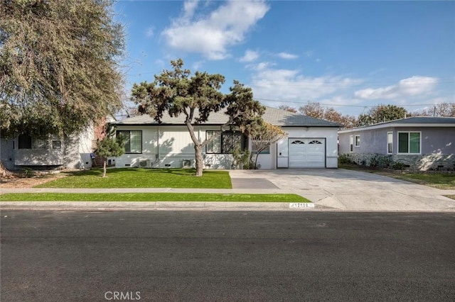 ranch-style home featuring a garage and a front lawn