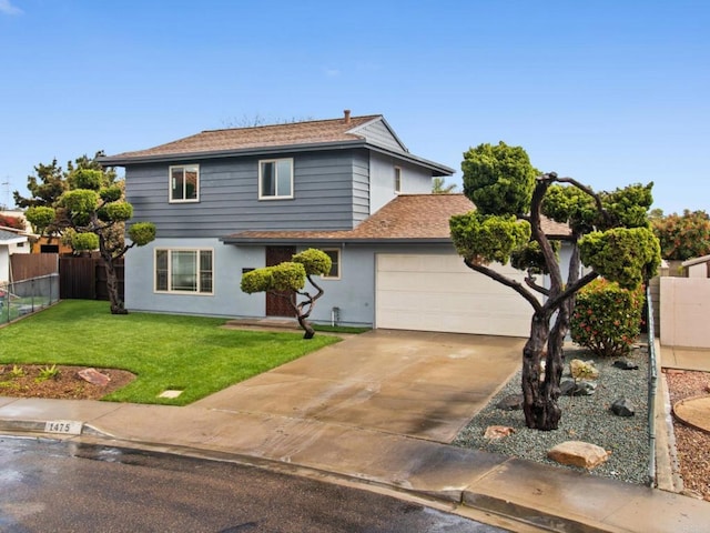 traditional home featuring fence, driveway, an attached garage, stucco siding, and a front lawn