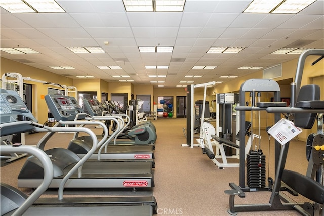 gym with a paneled ceiling