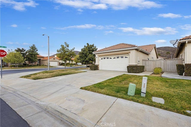 view of front facade with a garage and a front yard