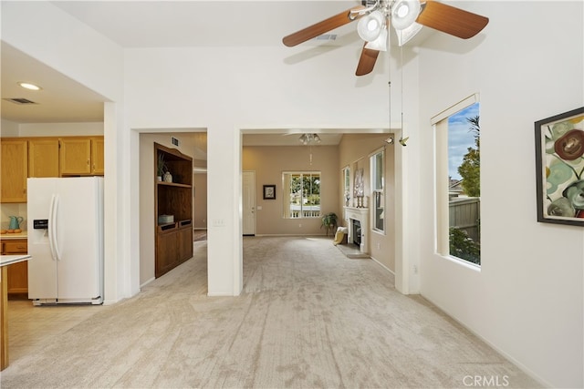 interior space with light colored carpet and ceiling fan