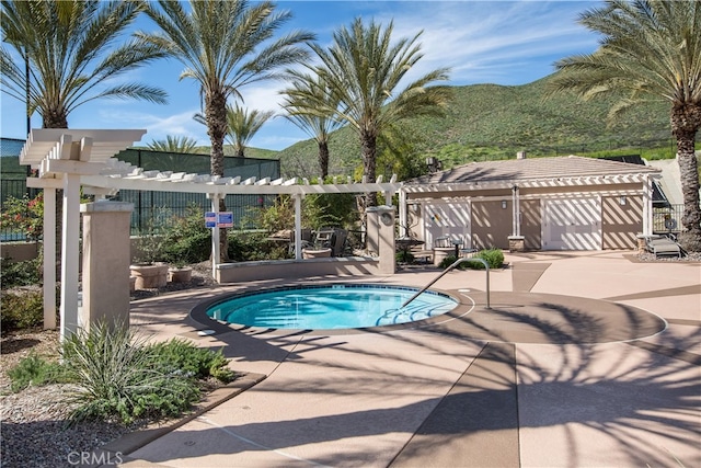 view of swimming pool with a pergola, a patio area, and a mountain view