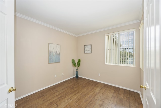 empty room featuring hardwood / wood-style floors and ornamental molding