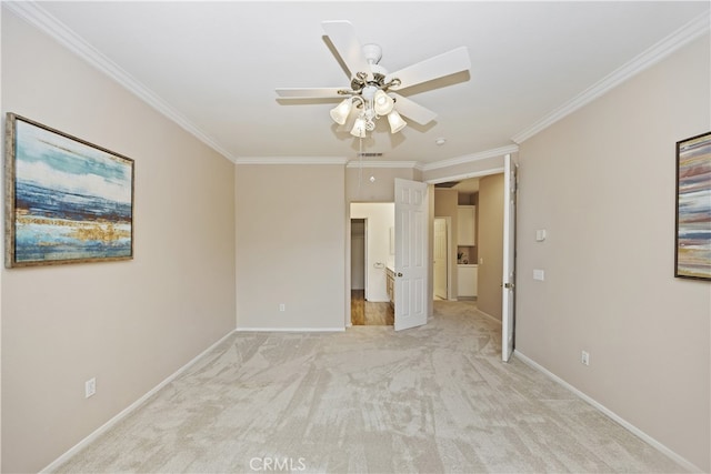 spare room featuring light carpet, crown molding, and ceiling fan