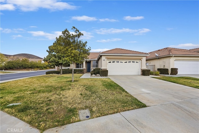 view of front of house with a garage, a mountain view, and a front yard