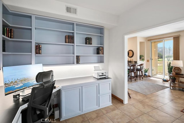 home office with light tile patterned flooring, visible vents, and baseboards