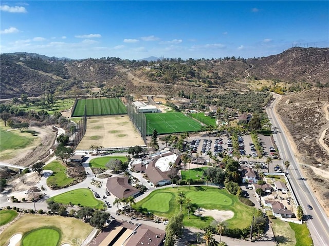 birds eye view of property with view of golf course and a mountain view