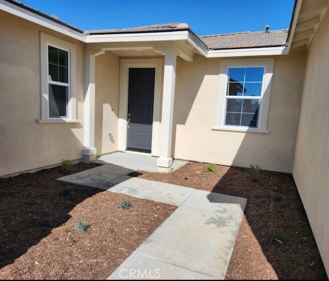 entrance to property featuring a patio area