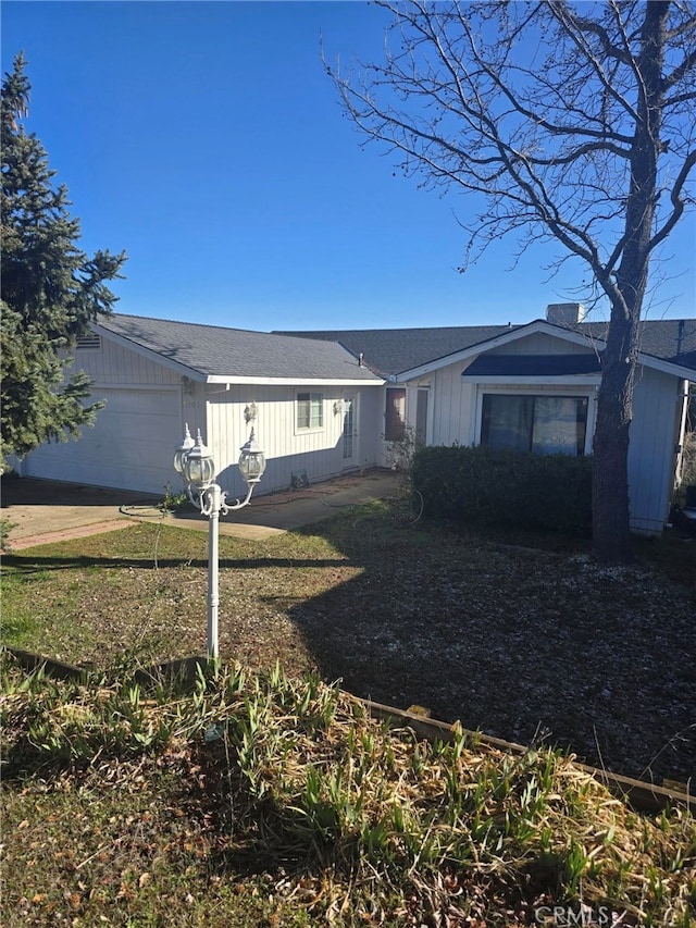 rear view of property featuring a garage