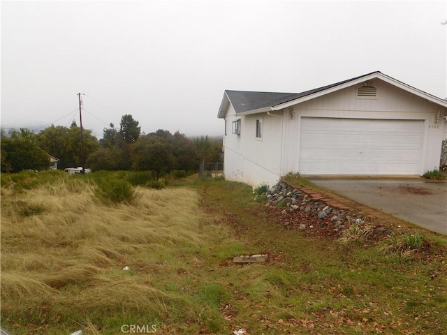 view of side of property featuring a garage