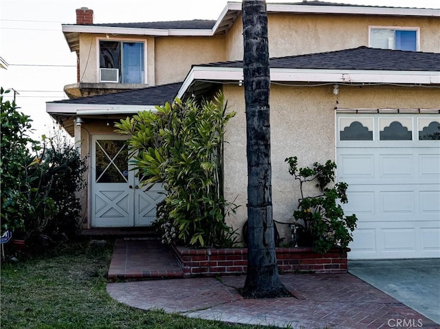 doorway to property with a garage