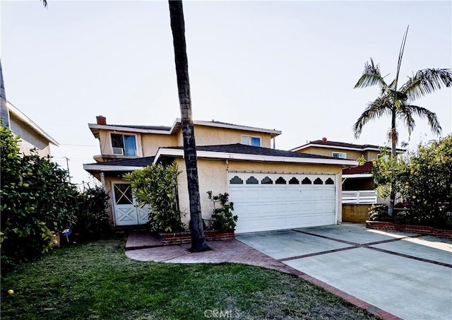 view of front facade featuring a garage and a front lawn