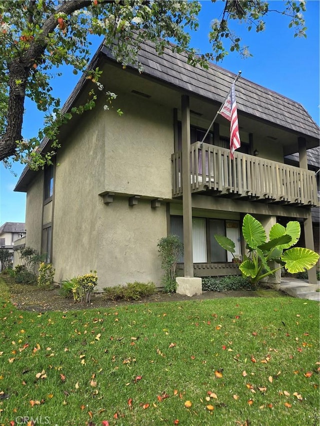 view of property exterior featuring a lawn and stucco siding