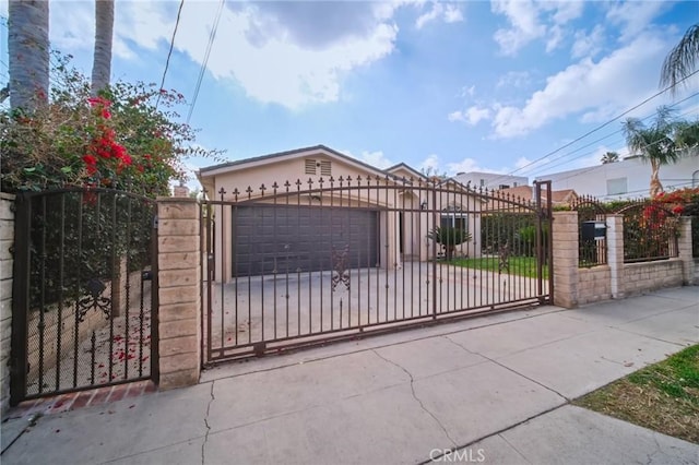 view of gate with a garage