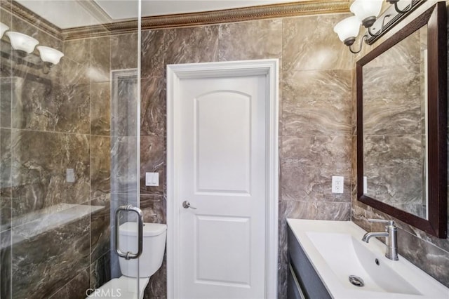 bathroom featuring sink, tile walls, and toilet