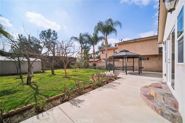 exterior space with a gazebo, a patio area, and a lawn