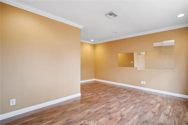 unfurnished room featuring wood-type flooring and ornamental molding