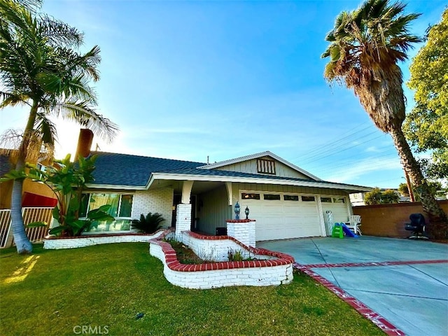 ranch-style house featuring fence, an attached garage, concrete driveway, a front lawn, and roof with shingles