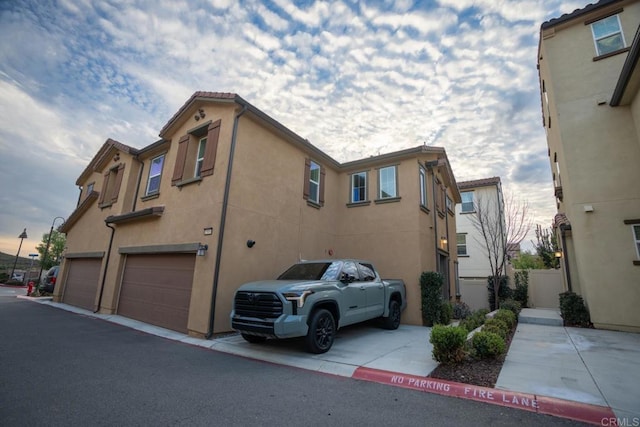 property exterior at dusk with a garage