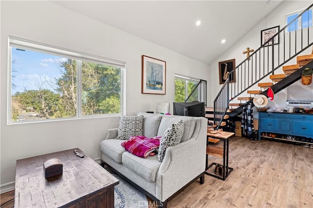 living room featuring vaulted ceiling and light hardwood / wood-style flooring