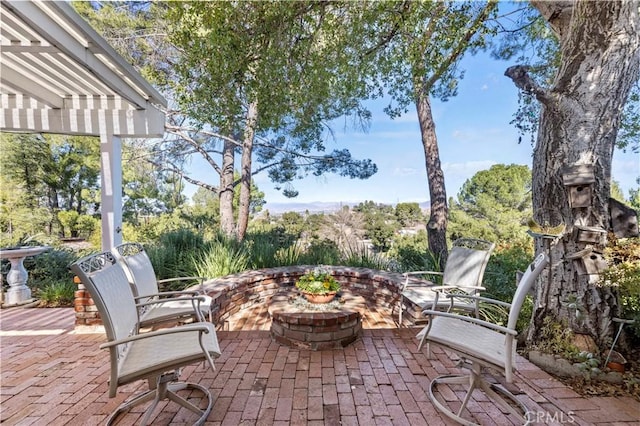 view of patio / terrace with a pergola and an outdoor fire pit