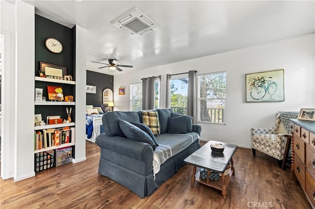 living room featuring hardwood / wood-style floors and ceiling fan