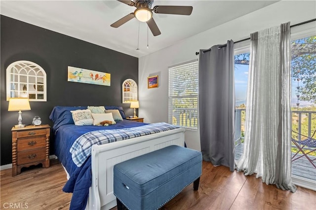 bedroom with ceiling fan, wood-type flooring, and access to exterior