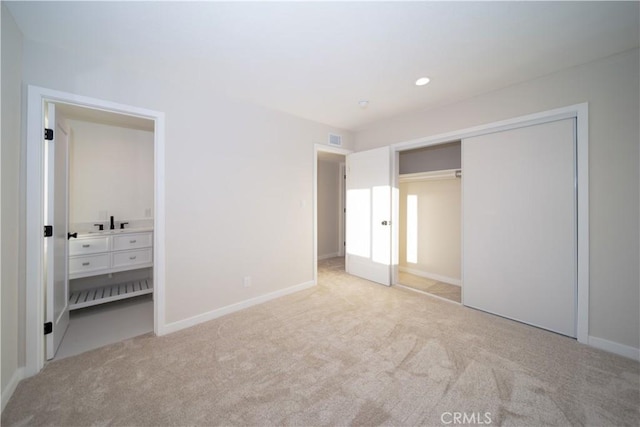 unfurnished bedroom featuring light carpet, visible vents, and baseboards