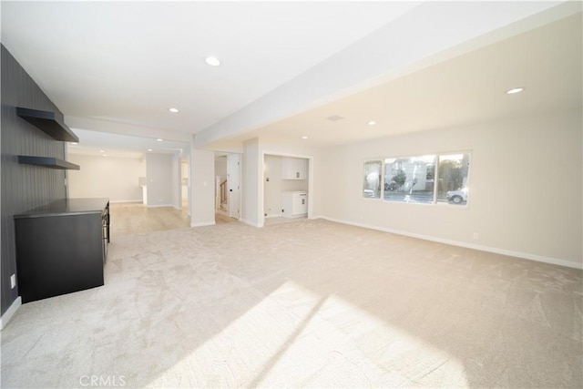 living room featuring light carpet, baseboards, and recessed lighting