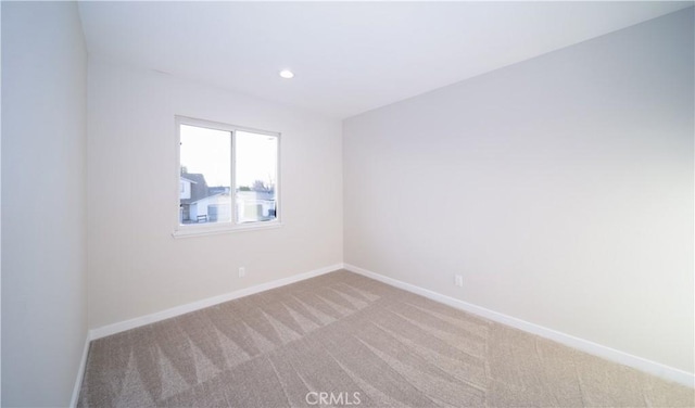 unfurnished room featuring light carpet, recessed lighting, and baseboards