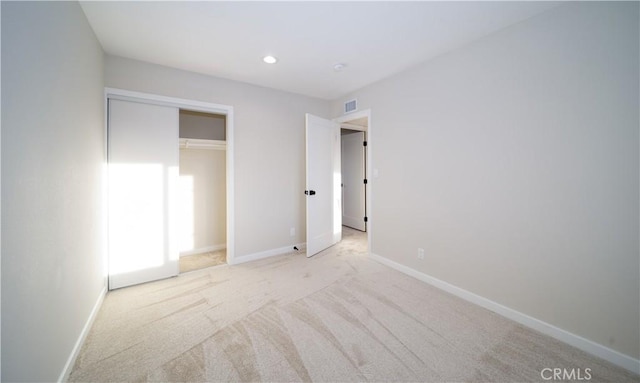 unfurnished bedroom with baseboards, recessed lighting, visible vents, and light colored carpet