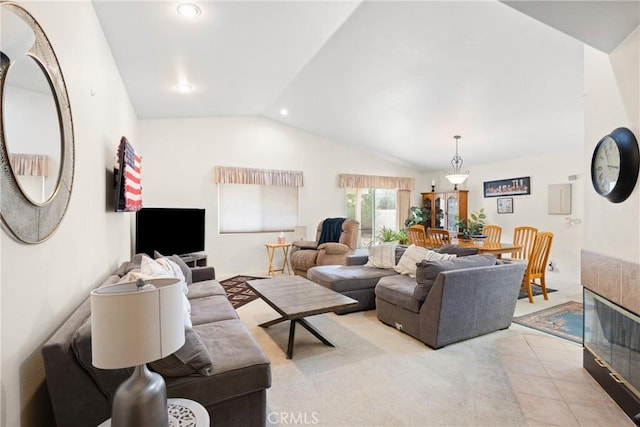 living room with lofted ceiling and light colored carpet