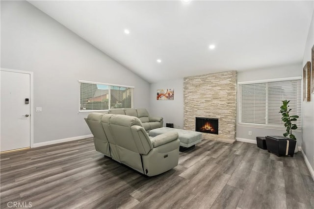 living room featuring high vaulted ceiling, dark wood-type flooring, and a fireplace