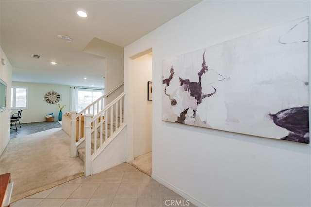 hall featuring light colored carpet