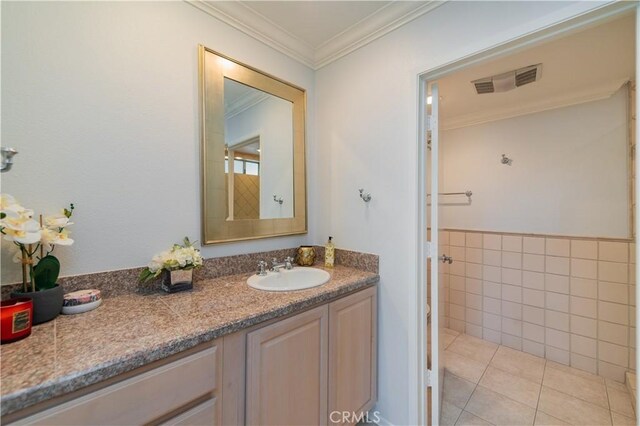 2381 Via Mariposa W Unit 2C, Laguna Woods, CA 92637 - bathroom with crown molding, vanity, tile walls, and tile patterned flooring