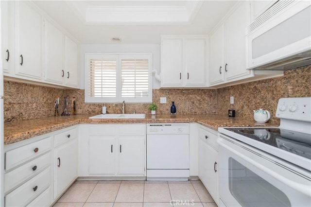2381 Via Mariposa W Unit 2C, Laguna Woods, CA 92637 - kitchen with white appliances, a sink, a tray ceiling, white cabinetry, and backsplash