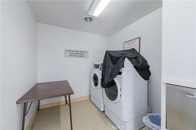 2381 Via Mariposa W Unit 2C, Laguna Woods, CA 92637 - washroom featuring washing machine and dryer and baseboards
