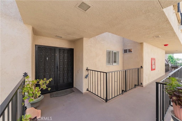 2381 Via Mariposa W Unit 2C, Laguna Woods, CA 92637 - entrance to property featuring french doors, stucco siding, and a balcony