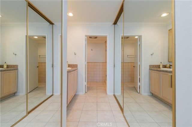 2381 Via Mariposa W Unit 2C, Laguna Woods, CA 92637 - full bathroom with tile patterned floors, ornamental molding, two vanities, tile walls, and a spacious closet