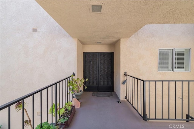 2381 Via Mariposa W Unit 2C, Laguna Woods, CA 92637 - entrance to property featuring stucco siding, a balcony, and french doors
