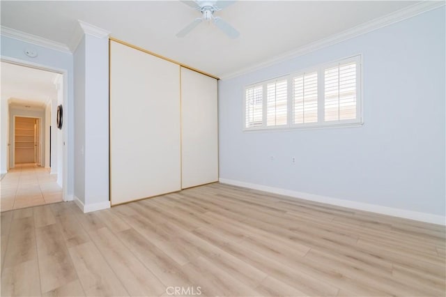 2381 Via Mariposa W Unit 2C, Laguna Woods, CA 92637 - unfurnished bedroom with crown molding, a closet, light wood-type flooring, baseboards, and ceiling fan