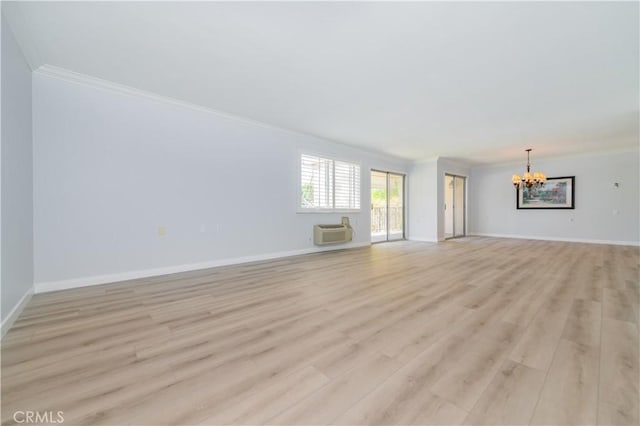 2381 Via Mariposa W Unit 2C, Laguna Woods, CA 92637 - unfurnished living room featuring crown molding, a chandelier, light wood-style floors, an AC wall unit, and baseboards