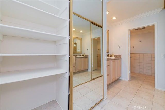 2381 Via Mariposa W Unit 2C, Laguna Woods, CA 92637 - bathroom featuring tile patterned floors, crown molding, two vanities, and recessed lighting