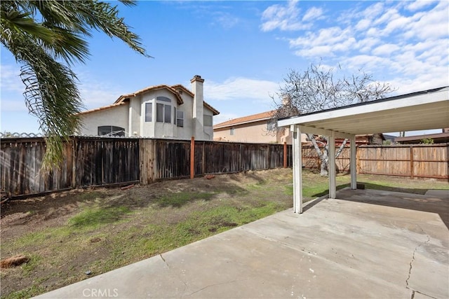 view of yard featuring a patio area and a fenced backyard