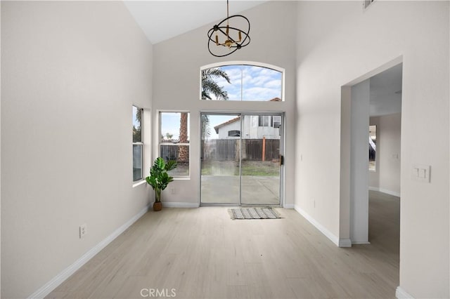 interior space featuring plenty of natural light, baseboards, and light wood-style flooring